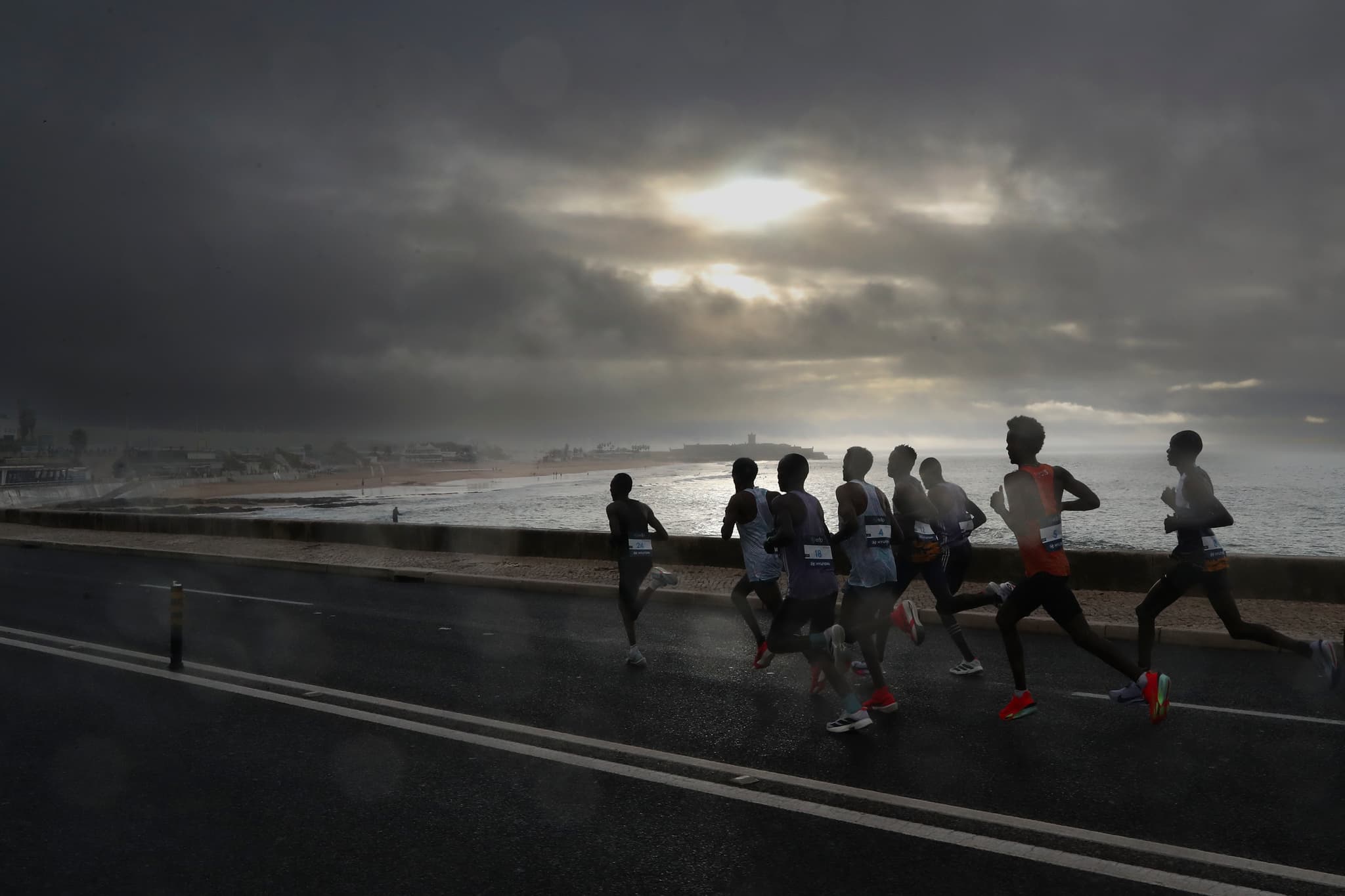 Runner by the sea at sunset
